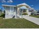 Charming single-Gathering home with a well-manicured lawn and a blue striped awning at 88 Bainbridge Dr # 88, Nokomis, FL 34275