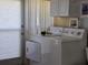 Functional laundry area with a modern washer and dryer setup, complemented by storage cabinets and ample natural light at 88 Bainbridge Dr # 88, Nokomis, FL 34275