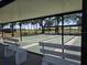 Covered shuffleboard courts with benches, offering a shaded recreation area with views of palm trees and open space at 88 Bainbridge Dr # 88, Nokomis, FL 34275
