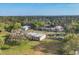 Aerial view of an acreage displays several outbuildings, mature trees, and a serene, rural setting at 964 1St Dirt Rd, Venice, FL 34292