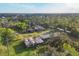 Expansive acreage shows a home with an adjacent agricultural structure, mature trees, and a sprawling green lawn at 964 1St Dirt Rd, Venice, FL 34292