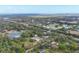 A high-definition aerial view displays a series of rural residences, foliage, and pond in the background at 964 1St Dirt Rd, Venice, FL 34292
