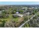 Aerial view of a home featuring numerous outbuildings, lush trees, and a road with adjacent residences at 964 1St Dirt Rd, Venice, FL 34292