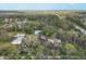 Expansive aerial view of a property featuring several structures surrounded by dense trees and foliage at 964 1St Dirt Rd, Venice, FL 34292