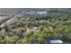 Aerial view of a property with structures surrounded by trees, showcasing the natural landscape at 964 1St Dirt Rd, Venice, FL 34292