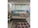 Comfortable bedroom with patterned bedding, side tables, and soft, sheer curtains for filtered light at 964 1St Dirt Rd, Venice, FL 34292