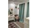 Bedroom featuring a vintage vanity, eclectic decor, with sheer curtains for privacy and decorative accents at 964 1St Dirt Rd, Venice, FL 34292