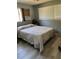 Calm bedroom features a comfortable bed, window with blinds, and minimalist decor for a serene setting at 964 1St Dirt Rd, Venice, FL 34292