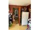 View of the laundry room and kitchen from the doorway, featuring a fridge, washer and dryer at 964 1St Dirt Rd, Venice, FL 34292