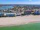 Aerial view showcases the condo's prime beachfront location, with views of the beach, ocean, and surrounding coastal landscape at 995 Laguna Drive # 303, Venice, FL 34285