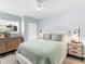 Comfortable bedroom featuring a bed, nightstand, and dresser at 995 Laguna Drive # 303, Venice, FL 34285