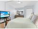 Inviting bedroom features a bed, TV, dresser, and closet at 995 Laguna Drive # 303, Venice, FL 34285
