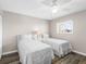 Cozy bedroom with twin beds, a ceiling fan, and natural light at 995 Laguna Drive # 303, Venice, FL 34285
