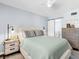 Bright bedroom featuring a comfortable bed, ceiling fan, and ensuite bathroom at 995 Laguna Drive # 303, Venice, FL 34285