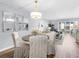 Cozy dining area with chandelier, decor mirrors, and hardwood floors, offering an inviting space for meals and gatherings at 995 Laguna Drive # 303, Venice, FL 34285