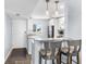 Bright kitchen featuring granite countertops, stainless appliances, bar stool seating, and open access to the entry door at 995 Laguna Drive # 303, Venice, FL 34285