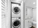 Convenient laundry closet with stacked washer and dryer, located adjacent to the updated bathroom, maximizing space and efficiency at 995 Laguna Drive # 303, Venice, FL 34285