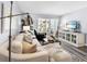 Comfortable living area featuring a sectional sofa, side console, and access to an outdoor balcony with beautiful beach views at 995 Laguna Drive # 303, Venice, FL 34285