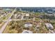 Expansive aerial view of condo buildings within a tree-filled community at 1051 Forrest Nelson Blvd # A-103, Port Charlotte, FL 33952