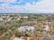 Scenic aerial view of the condo building and wooded surroundings under a blue sky at 1051 Forrest Nelson Blvd # A-103, Port Charlotte, FL 33952