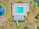 Aerial view of community pool with clear blue water, surrounded by lounge chairs and lush landscaping at 1051 Forrest Nelson Blvd # A-103, Port Charlotte, FL 33952