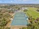 Aerial view of community tennis courts and sports fields with mature landscaping at 1051 Forrest Nelson Blvd # A-103, Port Charlotte, FL 33952