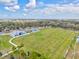 Aerial view of a well-maintained community football field with adjacent parking and playground at 1051 Forrest Nelson Blvd # A-103, Port Charlotte, FL 33952