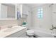 Well-lit bathroom featuring a tub and shower combo, a white vanity and a tiled backsplash at 1051 Forrest Nelson Blvd # A-103, Port Charlotte, FL 33952