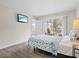 Comfortable bedroom with access to a screened porch, allowing for beautiful outdoor views at 1051 Forrest Nelson Blvd # A-103, Port Charlotte, FL 33952