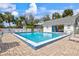 Inviting community pool surrounded by a brick patio, lounge chairs, and lush landscaping at 1051 Forrest Nelson Blvd # A-103, Port Charlotte, FL 33952