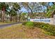 Bimini Bay Club entrance sign surrounded by lush landscaping and mature trees at 1051 Forrest Nelson Blvd # A-103, Port Charlotte, FL 33952