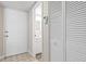 Clean entryway with white door, tile floor and convenient coat closet at 1051 Forrest Nelson Blvd # A-103, Port Charlotte, FL 33952