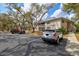 Exterior of condo building with cars parked in lot and mature trees in a landscaped community at 1051 Forrest Nelson Blvd # A-103, Port Charlotte, FL 33952