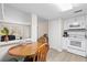 Cozy dining area next to a bright kitchen with white cabinetry and modern appliances at 1051 Forrest Nelson Blvd # A-103, Port Charlotte, FL 33952