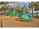 A fun colorful playground with slides, climbing structures, and more, all set on a wood chip base at 1051 Forrest Nelson Blvd # A-103, Port Charlotte, FL 33952
