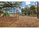 Community playground with slides, climbing structures, and swings on a wood chip safety surface at 1051 Forrest Nelson Blvd # A-103, Port Charlotte, FL 33952