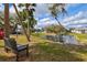 Relaxing view of the community pond with a bench, lush greenery, and clear water at 1051 Forrest Nelson Blvd # A-103, Port Charlotte, FL 33952