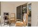 Comfortable screened-in porch with rocking chairs and a cat tree at 1051 Forrest Nelson Blvd # A-103, Port Charlotte, FL 33952