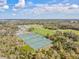 Aerial view of well-maintained tennis courts surrounded by lush greenery and sports fields at 1051 Forrest Nelson Blvd # A-103, Port Charlotte, FL 33952