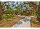 Meandering community walking path with shady trees and native plants at 1051 Forrest Nelson Blvd # A-103, Port Charlotte, FL 33952