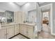 Bathroom with dual sinks, granite countertops, and a built-in vanity at 1115 Gladstone Blvd, Englewood, FL 34223