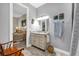 Bathroom vanity with granite countertops, stylish fixtures and an ensuite bedroom view at 1115 Gladstone Blvd, Englewood, FL 34223