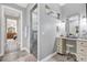 Well-lit bathroom featuring vanity with drawers, a seated vanity, and walk-in shower at 1115 Gladstone Blvd, Englewood, FL 34223
