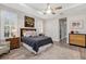 Serene bedroom with natural light, tray ceilings, and stylish wooden accents at 1115 Gladstone Blvd, Englewood, FL 34223