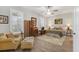 A bright bedroom offers a sitting area, wood floors, natural light, and soft decor at 1115 Gladstone Blvd, Englewood, FL 34223