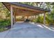 Large, covered carport with plenty of space for parking and storage, offering protection from the elements at 1115 Gladstone Blvd, Englewood, FL 34223