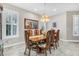 Traditional dining room featuring a wood table, patterned chairs, decorative lighting, and a window at 1115 Gladstone Blvd, Englewood, FL 34223