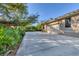 Driveway leading up to a two car garage and lush landscaping on a sunny day at 1115 Gladstone Blvd, Englewood, FL 34223