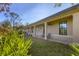 Well-maintained exterior features a covered porch and lush landscaping at 1115 Gladstone Blvd, Englewood, FL 34223
