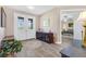 Bright foyer with decorative glass double doors and wood-look tile flooring at 1115 Gladstone Blvd, Englewood, FL 34223